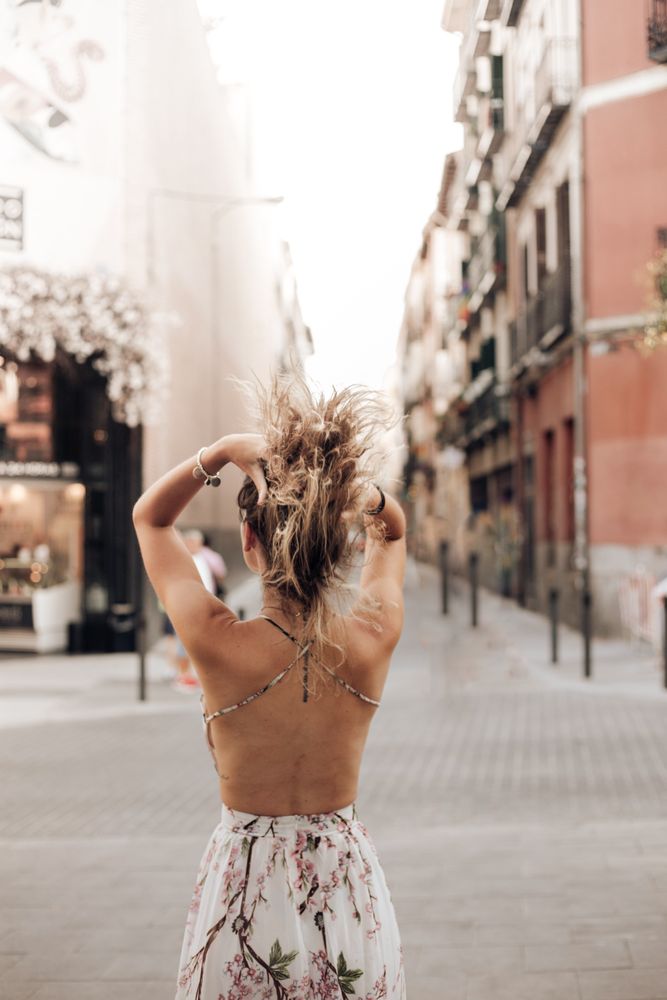 woman in summer dress walking on city