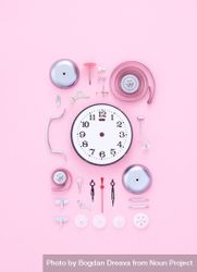 Clock dissembled on pink background 41y7Z4