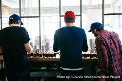 Back view of three men at coffee tasting 4ZeQW5