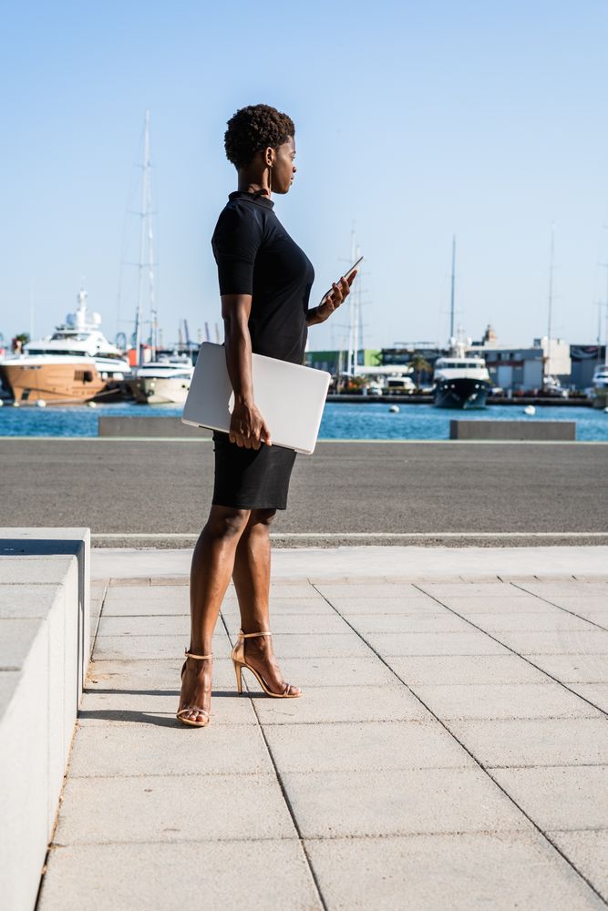 Black woman using mobile phone on the street