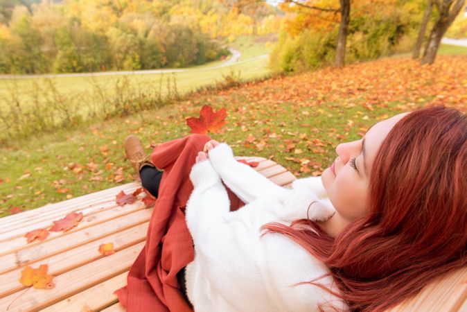 Woman relaxing on park bench enjoying the view