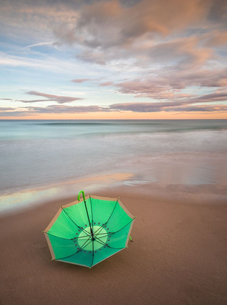 Umbrella on beach near sea