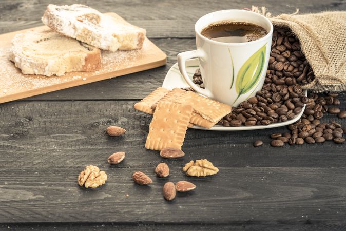 Coffee cup with biscuits and almonds