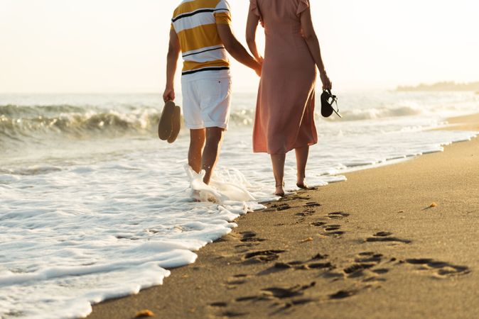 Adult couple walking towards sea
