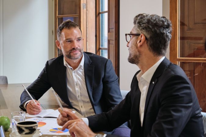 Colleagues looking to each other in office