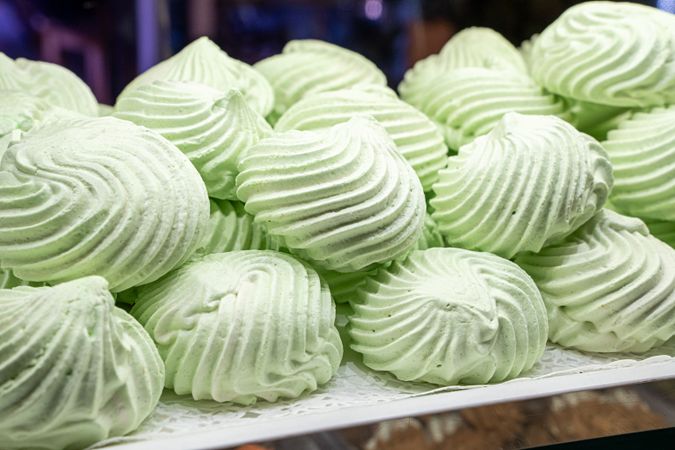 Fresh pistachio meringue cookies displayed light green swirled homemade sweet dessert pastry