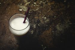 Glass of milk on table