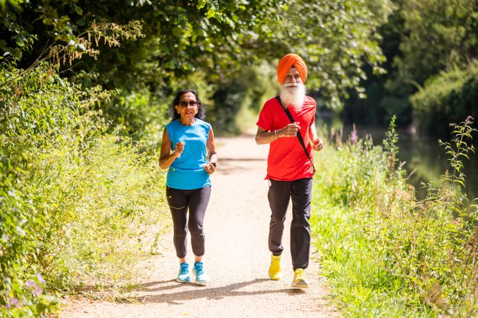 Older Sikh couple jogging