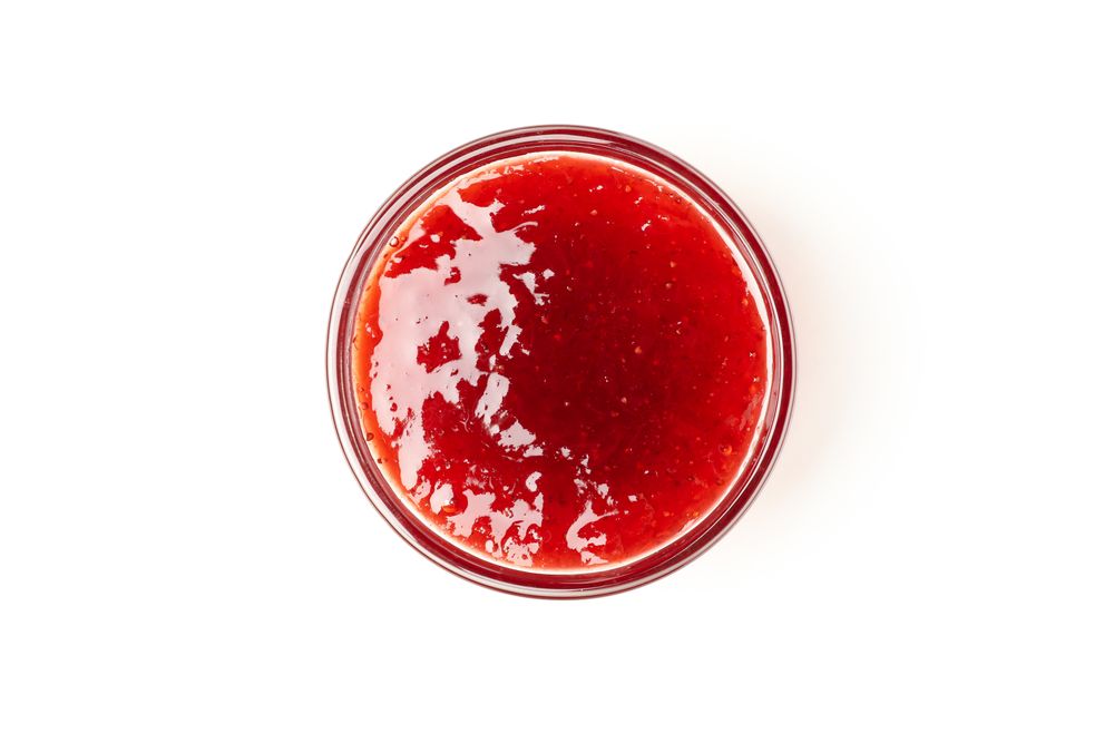 Delicious strawberry jam isolated on plain background