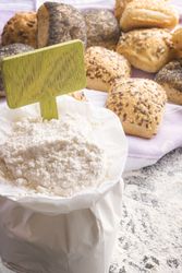Open flour bag with blank wooden banner