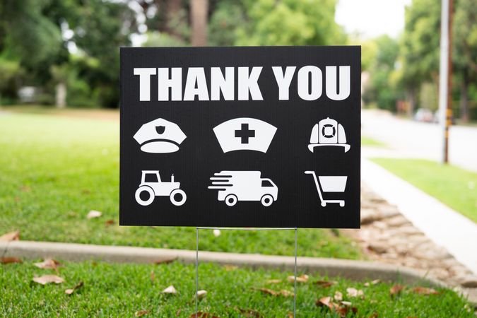 Close up of a thank you yard sign with icons