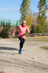 Older man sprinting in park