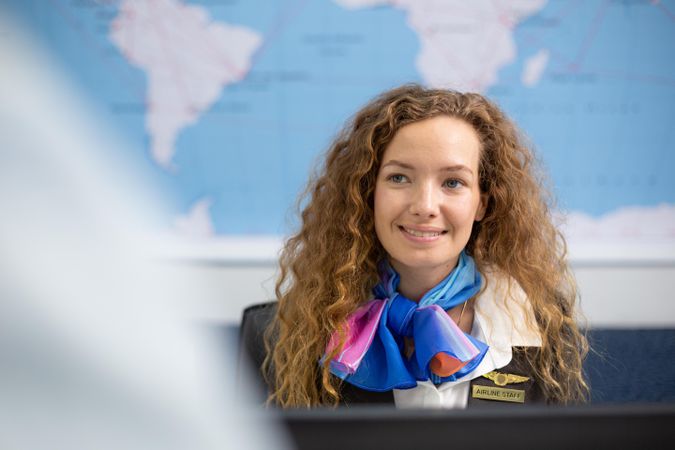 Woman working in airport with traveler at airport check in