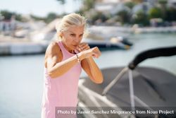 Mature woman doing sport in a coastal port bYy8jb