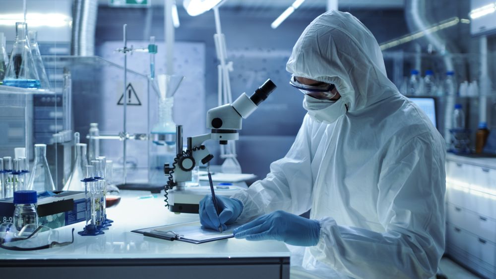 In a Secure High Level Research Laboratory Scientist Writing Down Experiment Results.