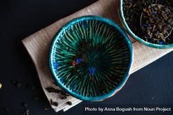 Tea time concept of blue bowls with petals 0Lz9R4