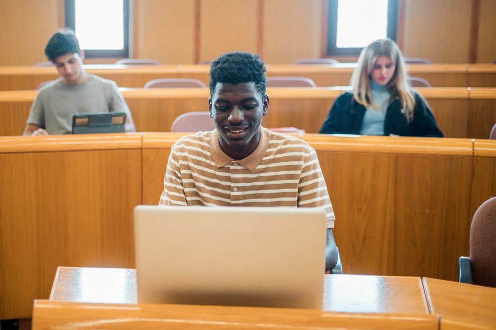 Black student using laptop during lesson
