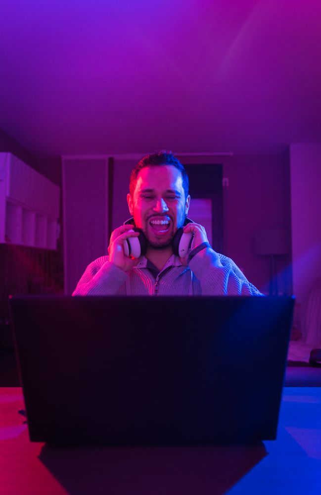 Man listening cheerfully to music with headphones.