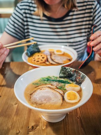 Female eating Japanese dish