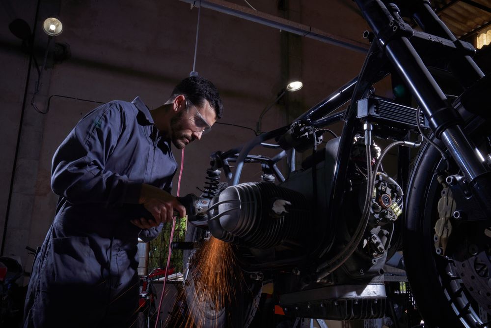Man repairing motorbike in garage