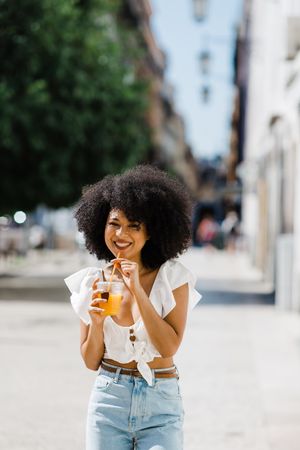Young Black female enjoying refreshing drink