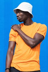 Black man in bright sporty outfit and cap
