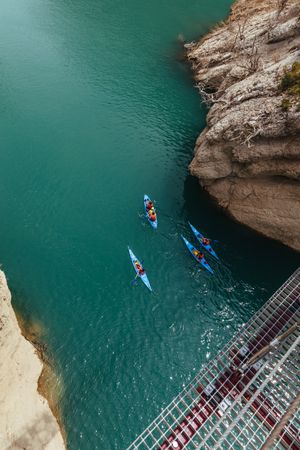 People crossing a river by kayak