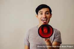 Hispanic male speaking through red loudspeaker 5613l0