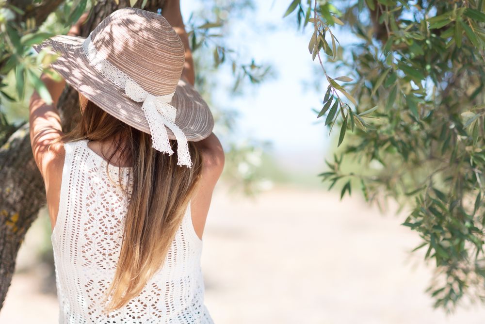 Adult woman standing near tree