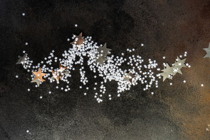 Christmas card concept of star confetti on table