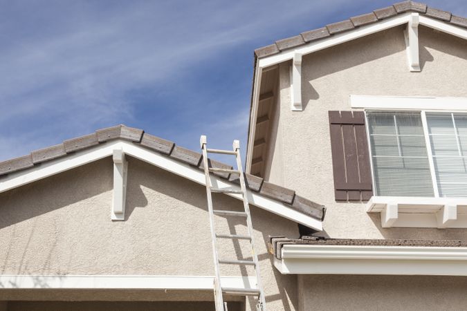 Ladder Leaning Up Against A Freshly Painted Home