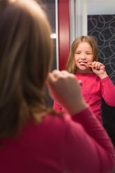 Cute girl brushing her teeth