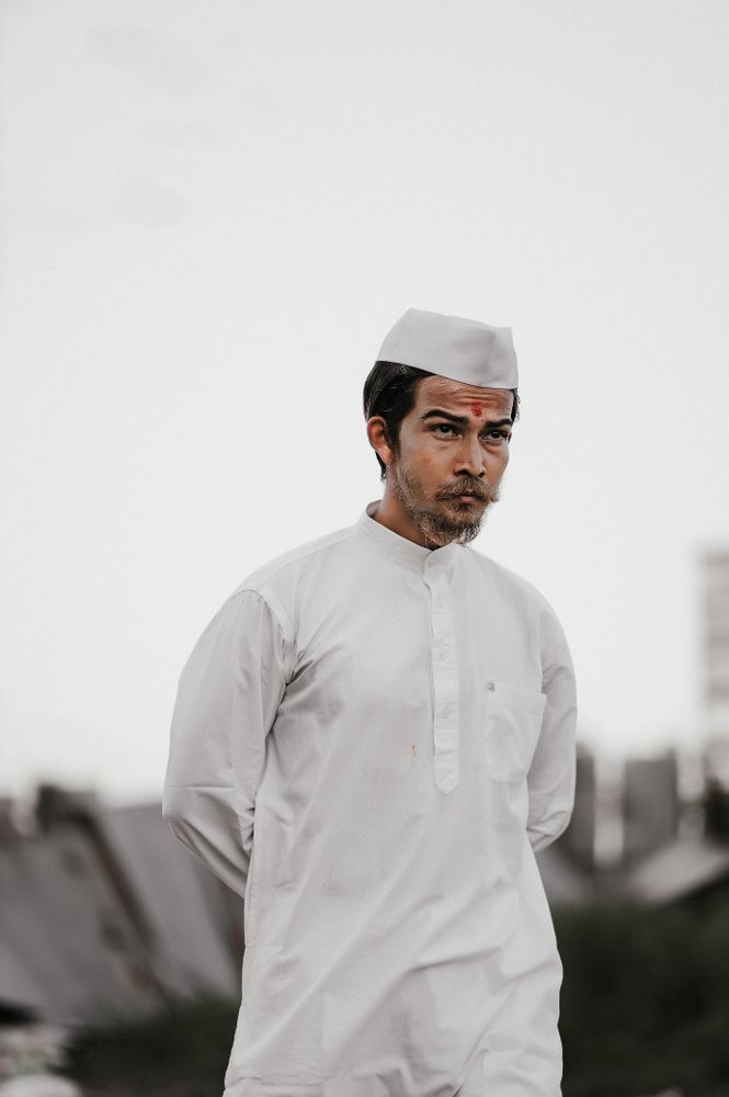 Young man with Tilaka wearing light thobe standing outdoor