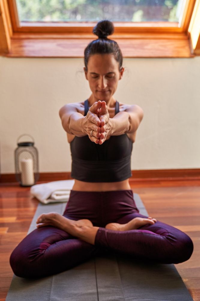Woman in Lotus pose and raised straight arms