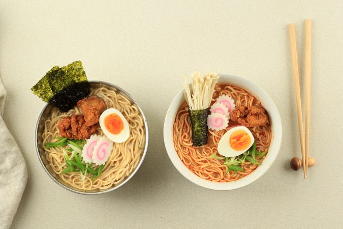 Two bowls of ramen with karaage chicken and egg toppings