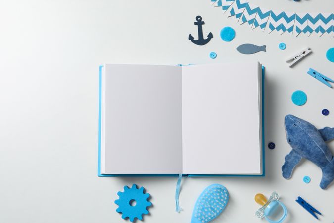Blue children's book, with toys, on a light background.