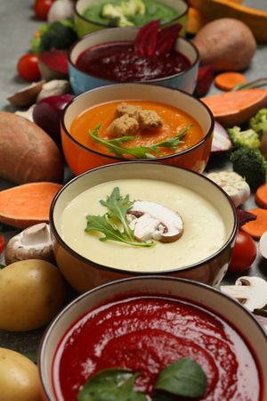 Close up of multi-colored soups, vertical composition