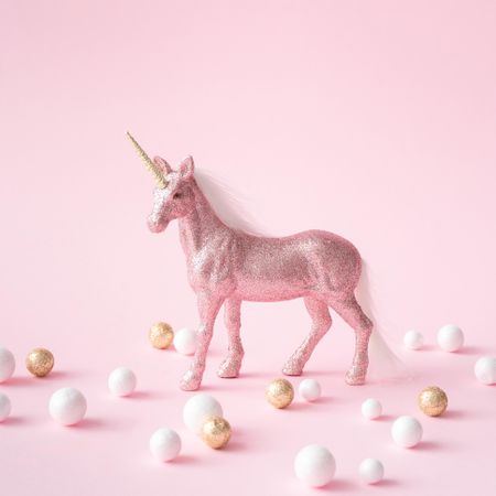 Pink glitter unicorn with gold and light-colored decorations