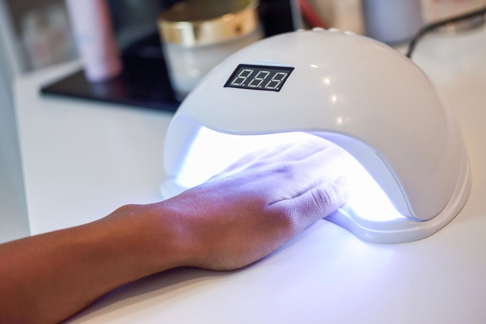 Manicured nails in UV lamp