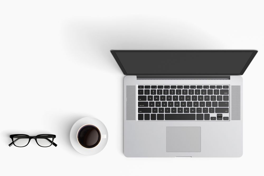 Modern workspace with coffee cup, smartphone, paper, notebook, tablet and laptop copy space
