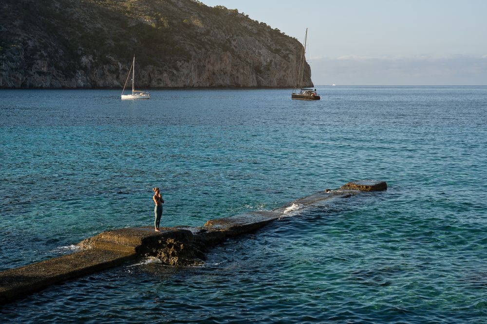 Woman doing yoga on pier