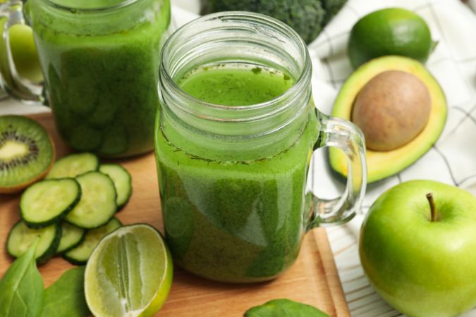 Concept of healthy food with smoothie, vegetables and fruits on wooden table