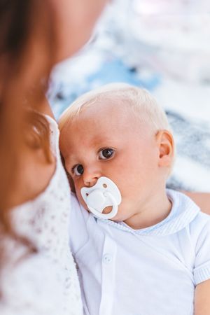 Blond baby with pacifier