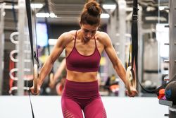 Muscular woman in gymnastic hoops at gym