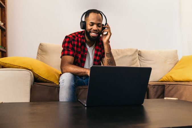 Black man making work video call with laptop at home