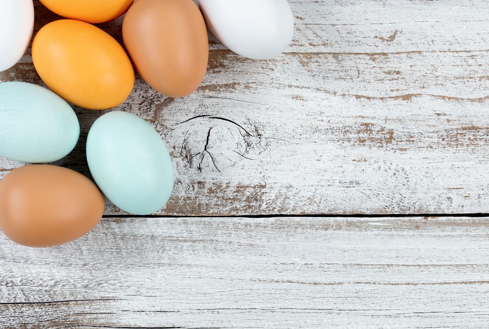 Natural colorful real eggs on rustic wood
