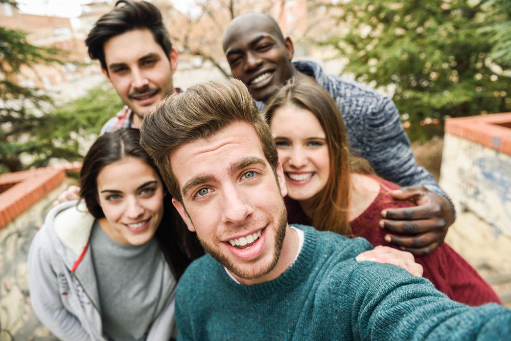 Group of friends looking at camera and posing for picture