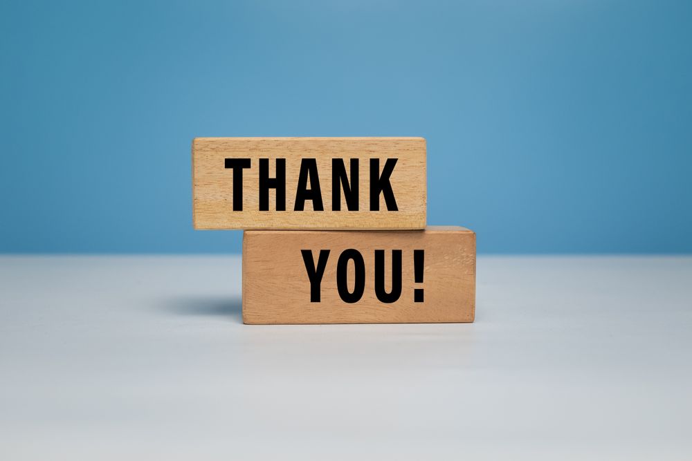 thank words symbol on wooden blocks isolated on grey background