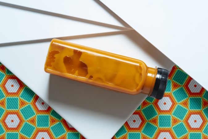 Mango and pumpkin smoothie bottle over retro textures