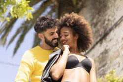 Happy couple flirting on street